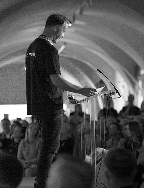 A male presenter on stage