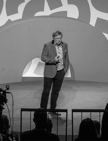 A male presenter on stage