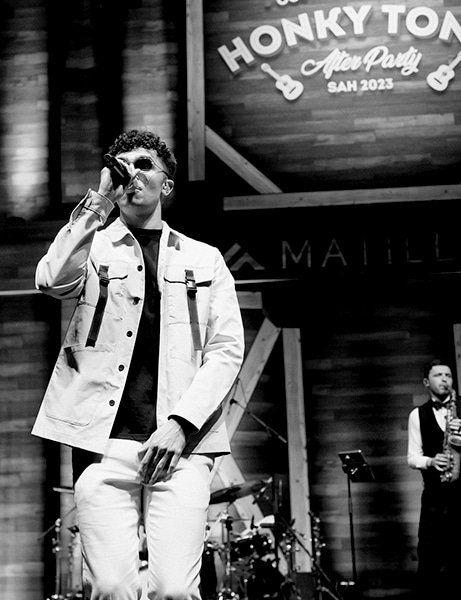 Music artist performing on stage with a microphone